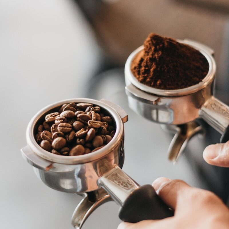 person holding gray coffee racks