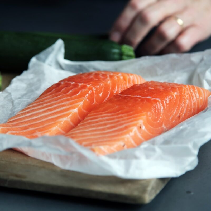 raw fish meat on brown chopping board