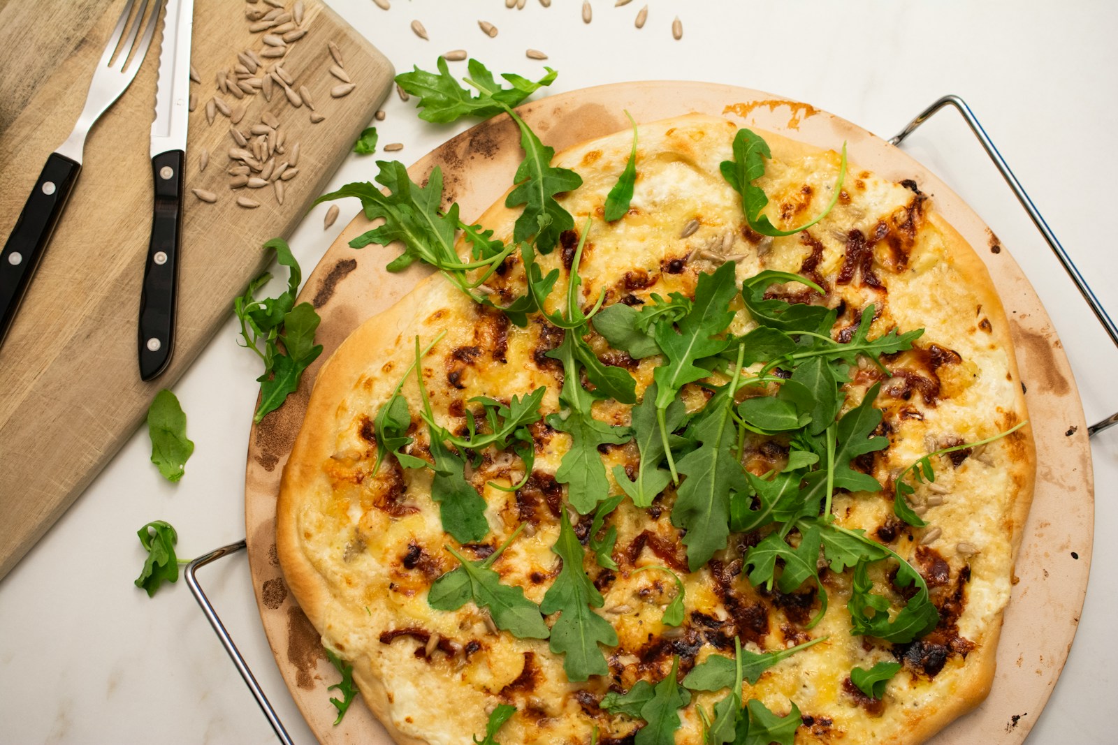 a pizza sitting on top of a wooden cutting board